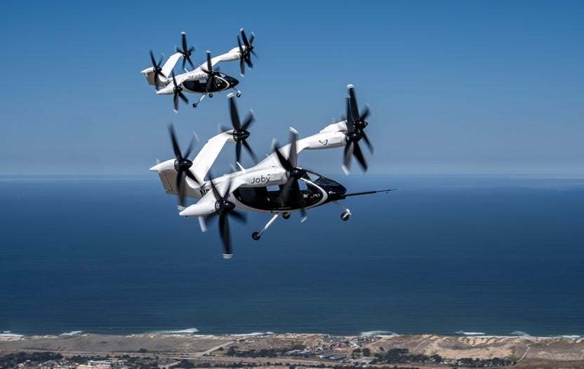 Two Joby air taxis (N541JX and N544JX) flying simultaneously in the skies over Marina, CA. Joby Aviation photo